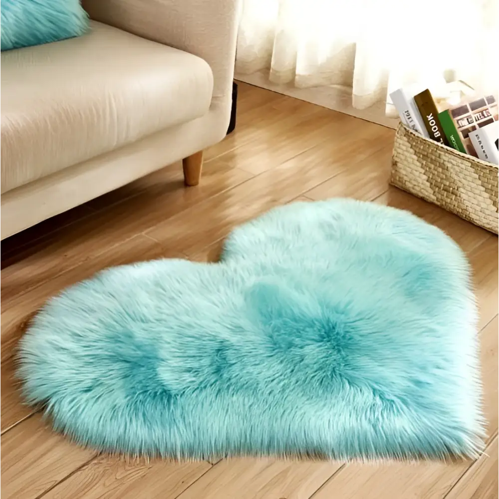 A mint green plush heart shaped living room rug with a soft faux fur texture and light turquoise color
