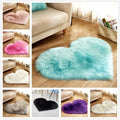 A plush heart shaped living room rug in mint green with long fluffy faux fur texture for cozy decor