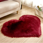 A plush heart shaped living room rug in deep red with a soft fluffy texture contrasting the mint green plush theme