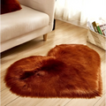 A plush heart shaped living room rug in rust color with soft faux fur texture for cozy decor