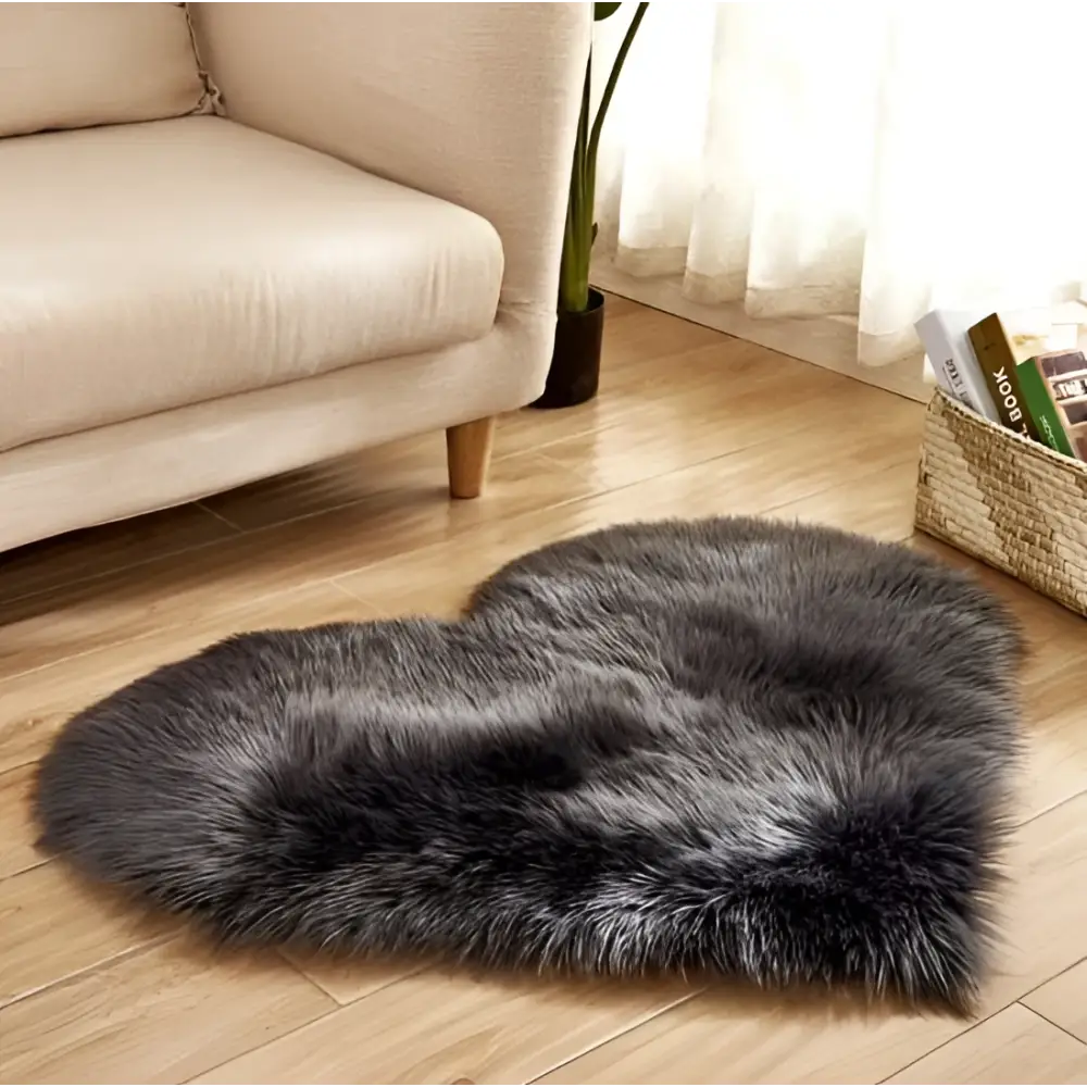 A plush heart shaped living room rug in dark gray faux fur contrasting with the mint green plush decor