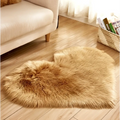 A plush heart shaped living room rug in golden brown faux fur complementing a mint green plush decor