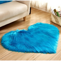 Mint green plush heart shaped living room rug with bright turquoise faux fur texture for cozy decor