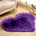 A plush heart shaped living room rug in vibrant purple with soft faux fur texture, contrasted to mint green plush options
