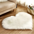 White fluffy heart shaped living room rug with soft faux fur texture complementing mint green plush decor