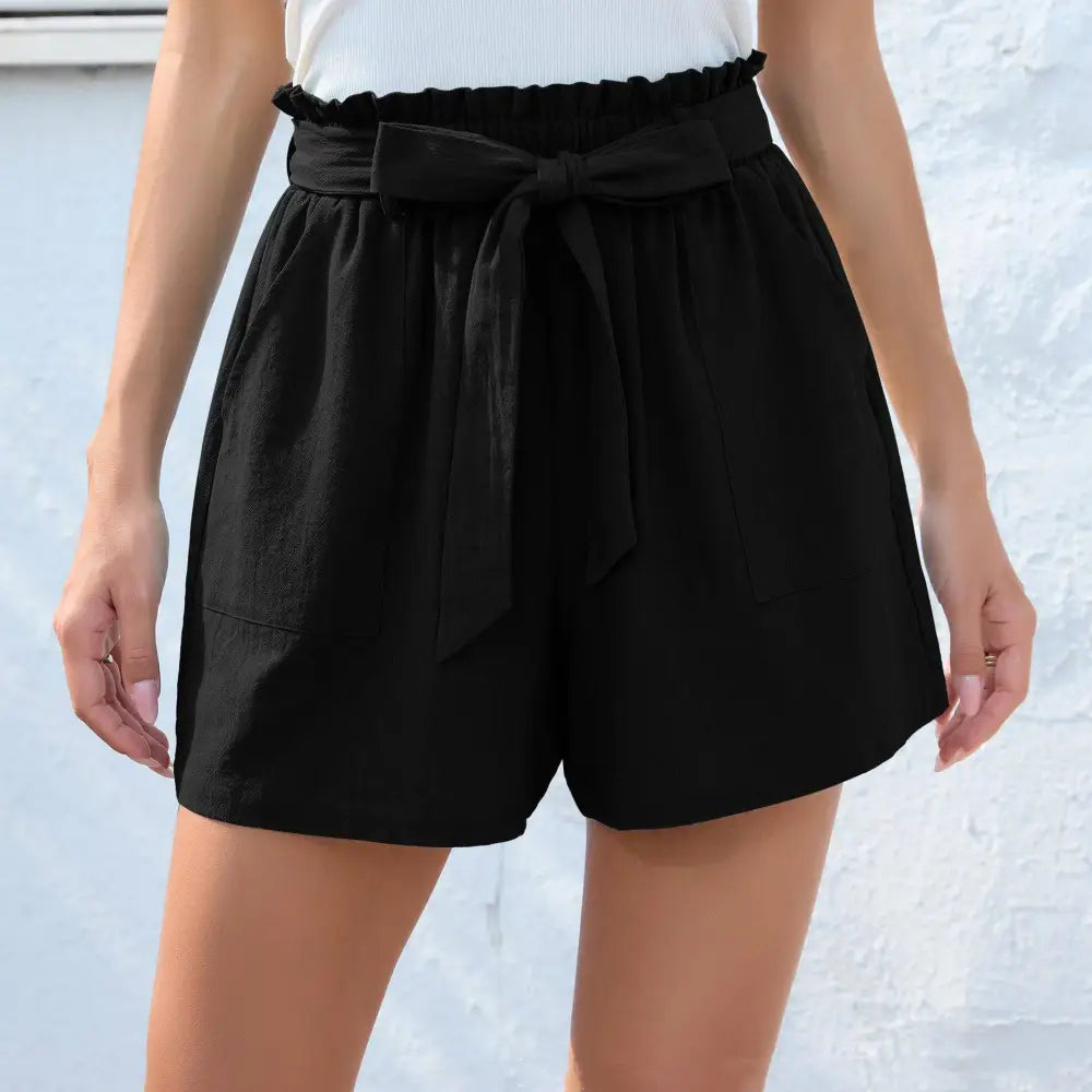 Black high-waisted shorts with ruffle bow waist elastic waistband and matching fabric tie bow