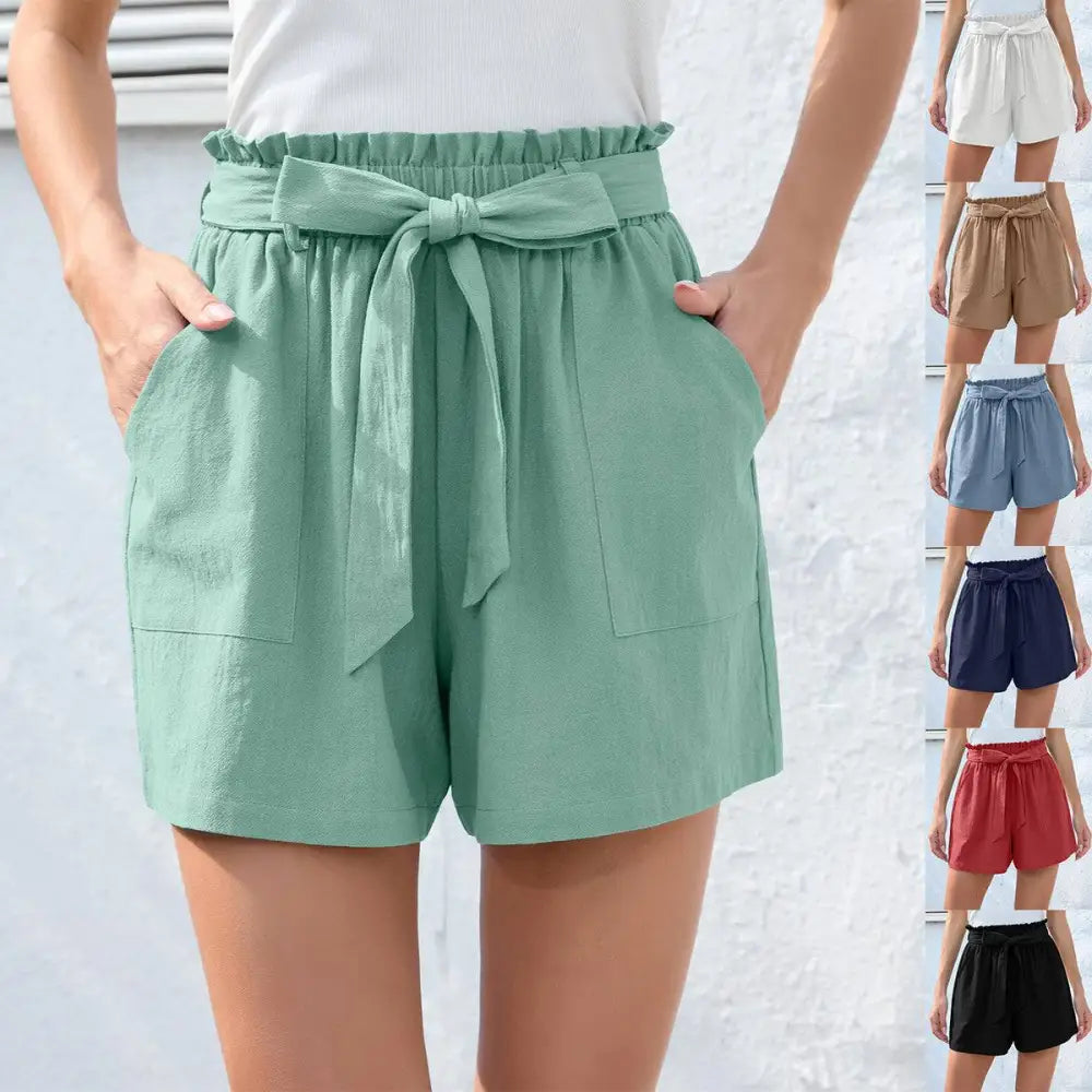 Mint green high-waisted shorts with ruffle bow waist tie and front pockets for stylish casual wear