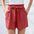 Red linen high-waisted shorts with ruffle bow waist tie and two front pockets contrasting mint green style