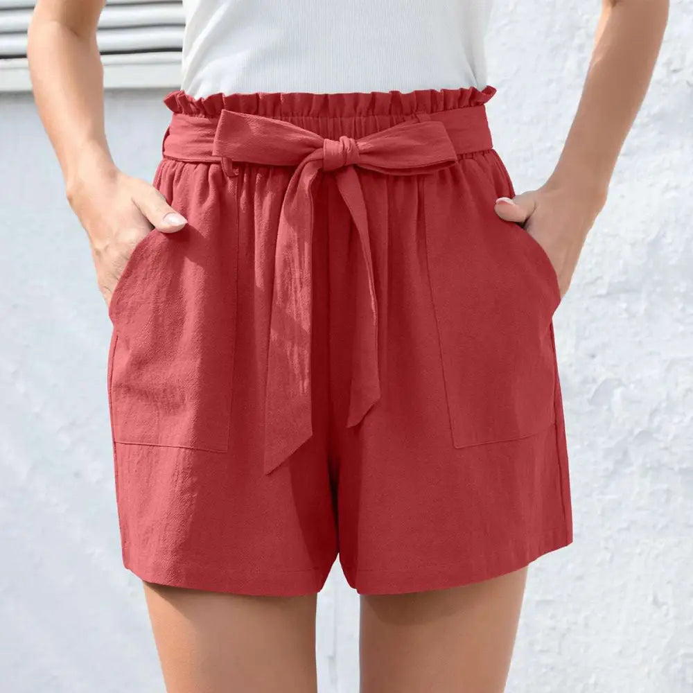 Red linen high-waisted shorts with ruffle bow waist tie and two front pockets contrasting mint green style