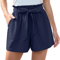 Navy blue high-waisted shorts with ruffle bow waist tie and front pockets in a stylish casual design
