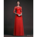 A vibrant red long sleeve lace gown with three-quarter sleeves and a flowing pleated skirt