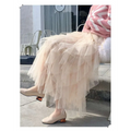 A flowing peach tulle skirt with ruffled hemline showcasing mesh stitching in a mint green tiered easy matching design
