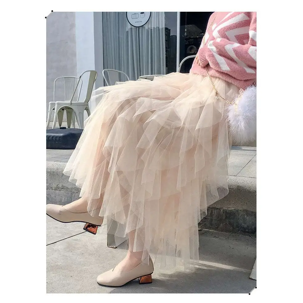 A flowing peach tulle skirt with ruffled hemline showcasing mesh stitching in a mint green tiered easy matching design