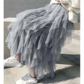 A flowing gray tulle skirt with layered mesh stitching and ruffled hemline in mint green tiered design