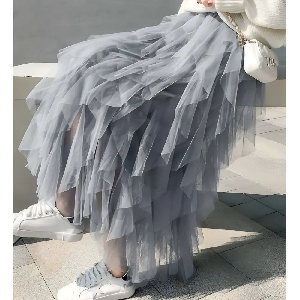 A flowing gray tulle skirt with layered mesh stitching and ruffled hemline in mint green tiered design