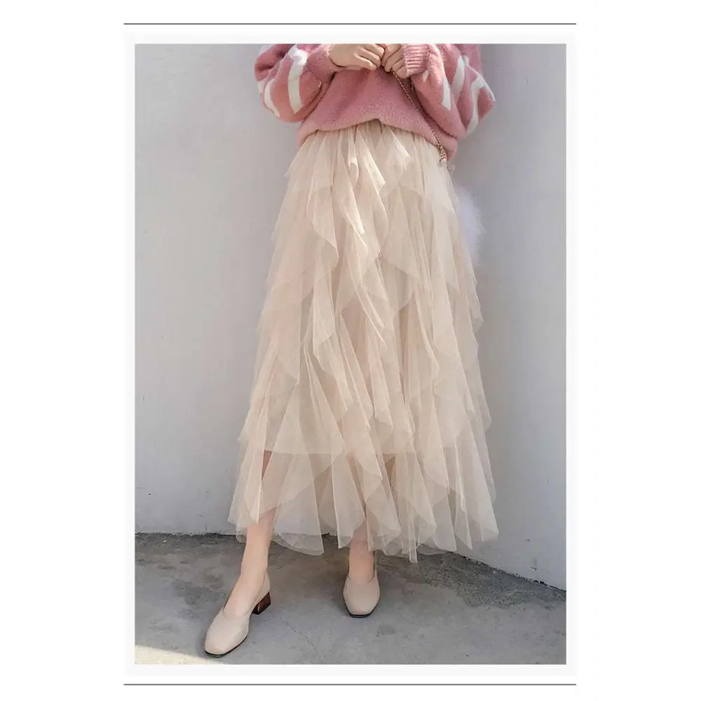 A flowing beige tulle skirt with soft ruffles and mesh stitching in the style of a mint green tiered easy matching skirt