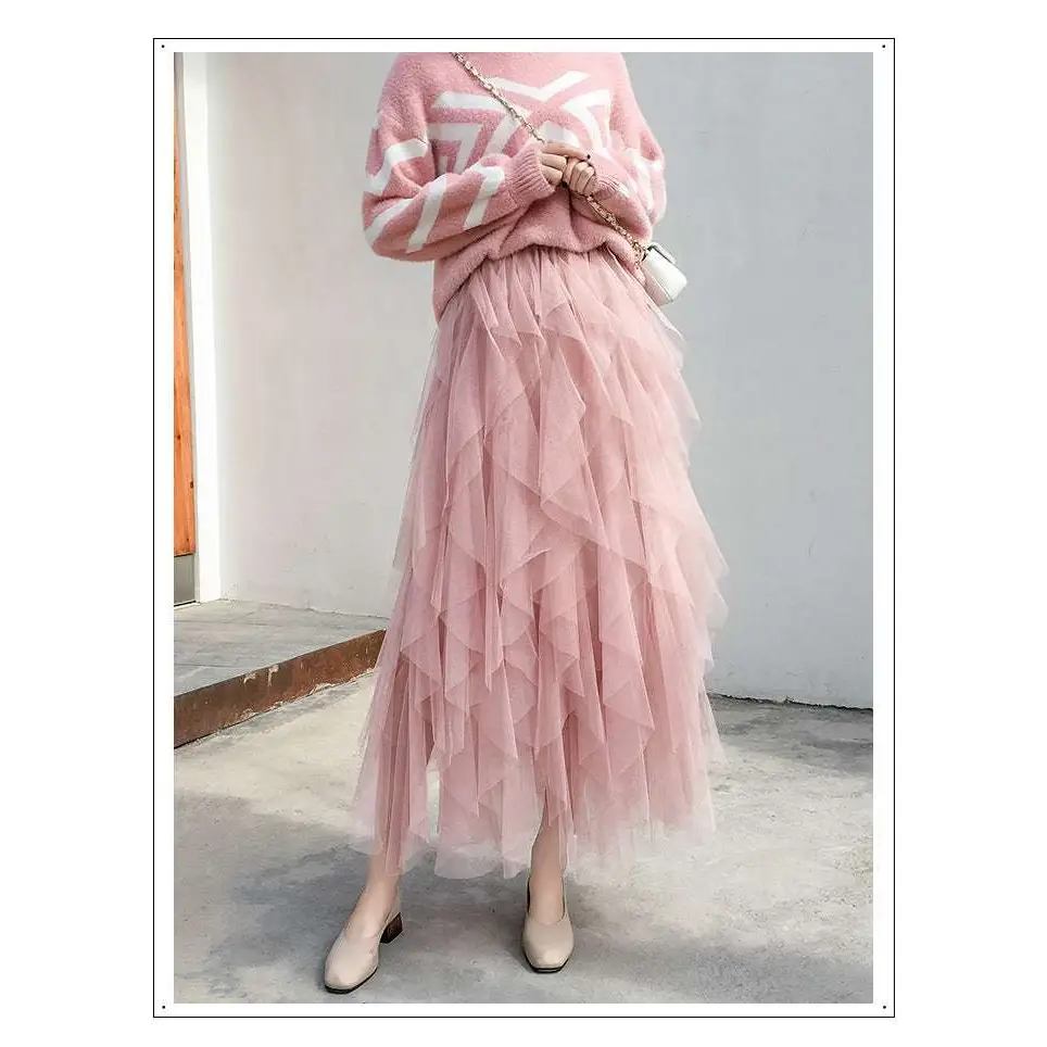 A flowing layered pink tulle skirt with mesh stitching and ruffled hemline complements the mint green tiered mesh skirt