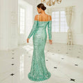 A shimmering mint green sequined sheath fishtail gown with long sleeves and an off-the-shoulder neckline