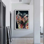 Modern abstract zebra canvas painting featuring two zebras with swirling rainbow stripes on black background framed white