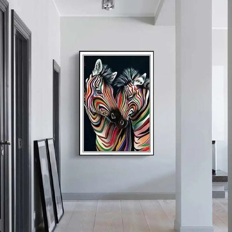 Modern abstract zebra canvas painting featuring two zebras with swirling rainbow stripes on black background framed white