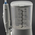 Modern electric tooth punch in white with a clear tank marked in ounces and milliliters and a blue-tipped punch water flosser nozzle