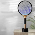 Black and gold electric mosquito swatter with glowing blue mesh for modern home bedroom use