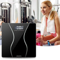 Modern household electronic scale with black glass surface and sleek curved white accent lines for home use
