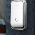 Modern white and silver wireless door bell with a minimalist design and embossed bell icon by login brand