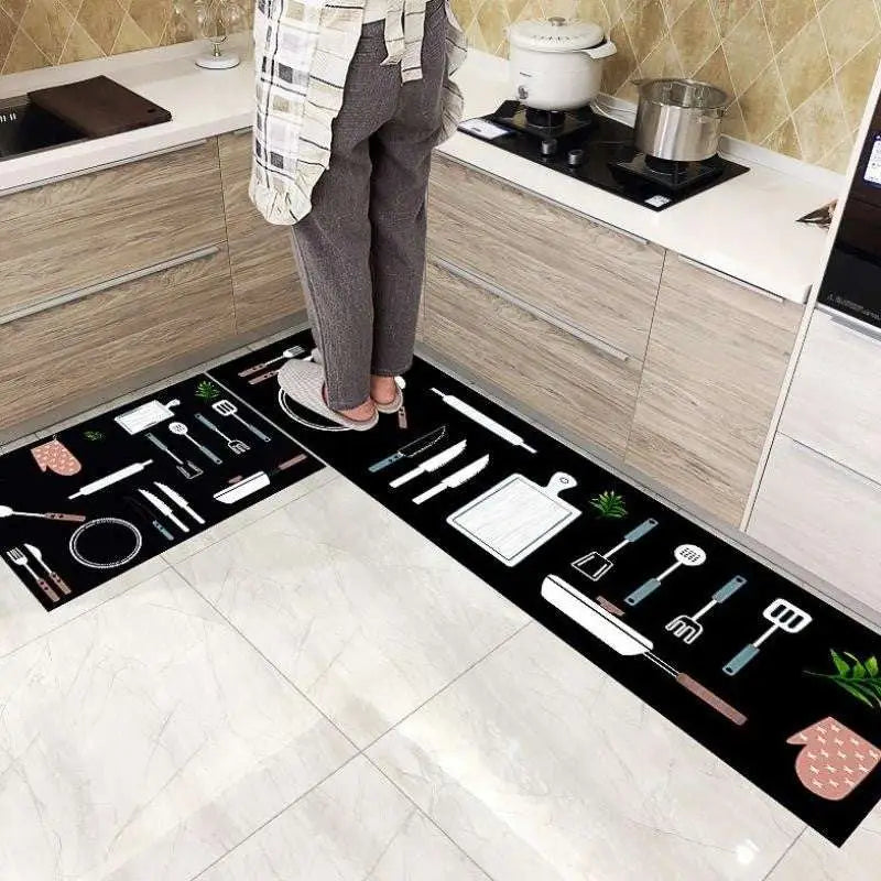 Black mosaic tile kitchen floor mat with white and pink cooking utensil illustrations, environmentally friendly design