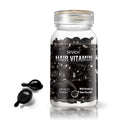 Sevich hair care capsules in a clear glass bottle with shiny black gel ampoules and a gold rim for multicolor hair care benefits