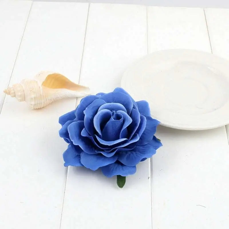 A vibrant blue artificial rose with layered petals and green stem made from synthetic fabric for flocking cloth headdress hairpin