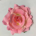 A delicate pink artificial rose with layered petals in a multicolor red roses flocking cloth headdress hairpin