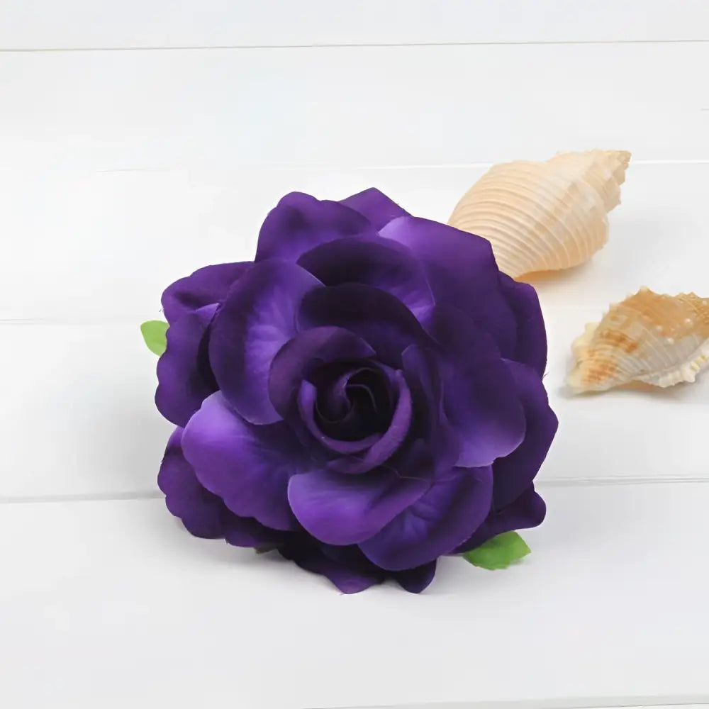 A deep purple artificial rose with layered petals and green leaves in a multicolor red roses flocking cloth headdress hairpin