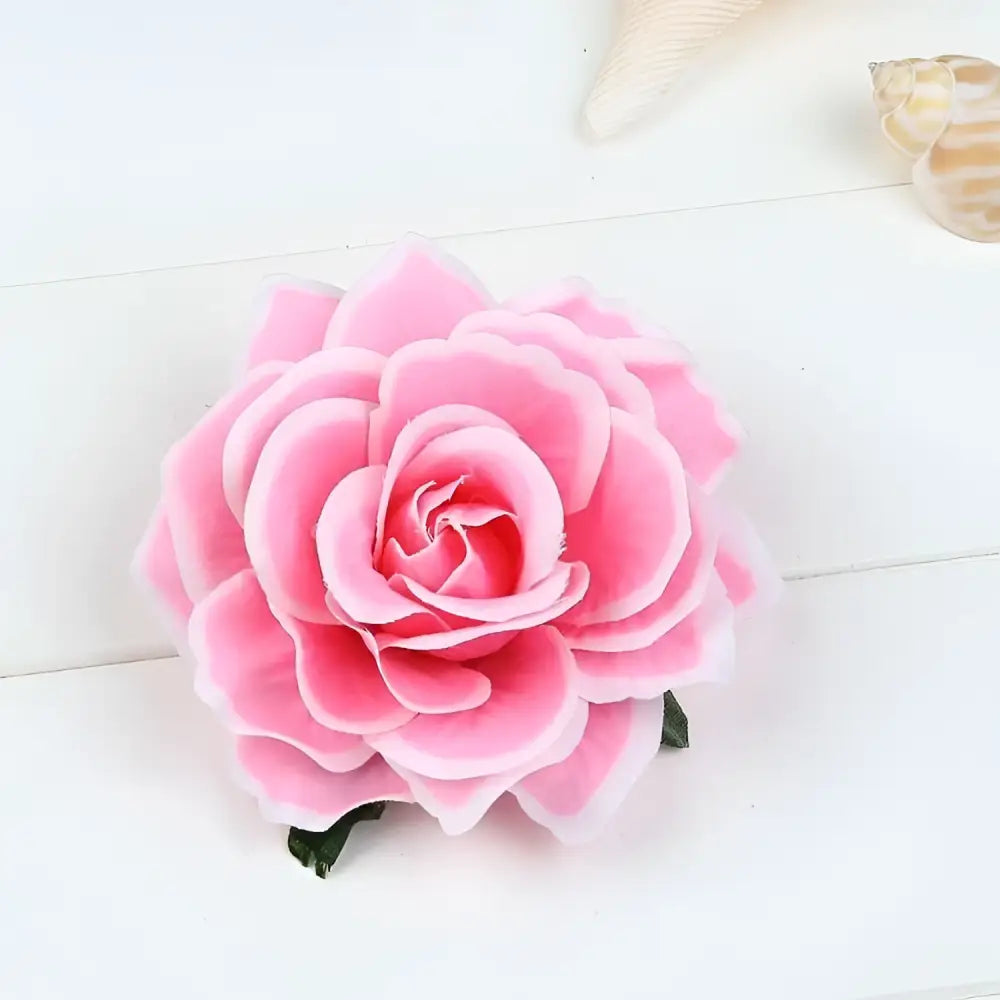 A soft pink cloth headdress hairpin featuring flocking cloth petals and a small green stem base for elegant wear
