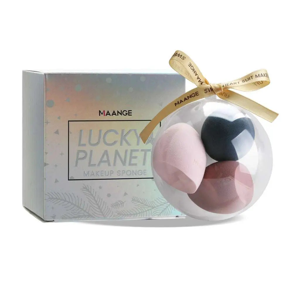 Clear spherical gift box containing three multicolored hydrophilic polyurethane beauty egg makeup sponges in pink black and mauve