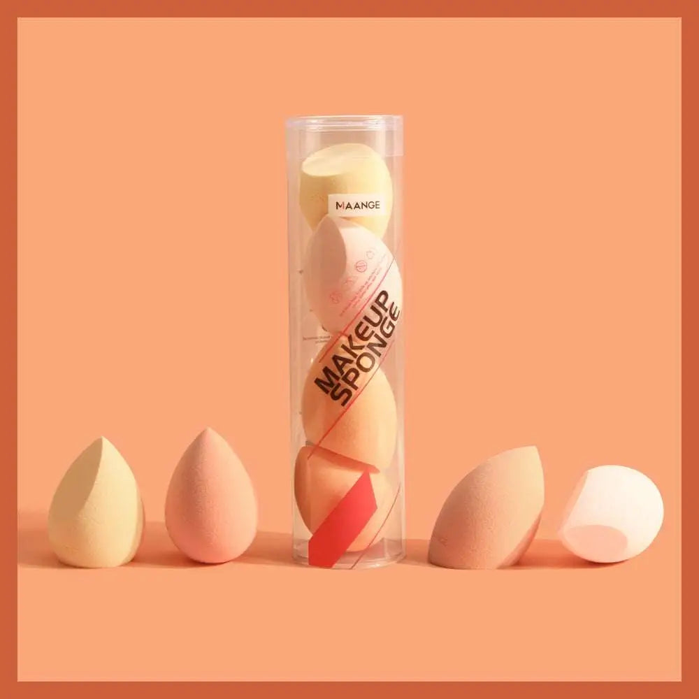 A set of pastel peach and cream hydrophilic polyurethane beauty egg makeup sponges arranged around maange packaging