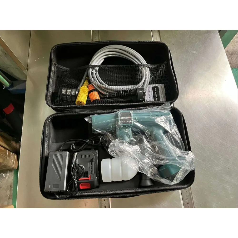 Teal and black multifunctional car wash pressure water gun in clear plastic wrap with battery pack and hose in carrying case