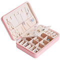 Pink faux leather multifunctional jewelry storage box with built-in mirror and detachable beige earring tray
