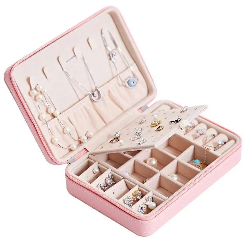 Pink faux leather multifunctional jewelry storage box with built-in mirror and detachable beige earring tray