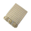 Soft woven knitted sofa blanket with mustard yellow geometric pattern and matching tassels on light gray background