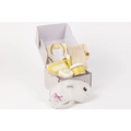 White embroidered eye mask with purple and pink floral designs in natural citrus bath body skincare set including shower steamer