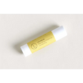 Yellow-labeled lip balm with white cap featuring minimalist branding in natural citrus bath and body skincare set