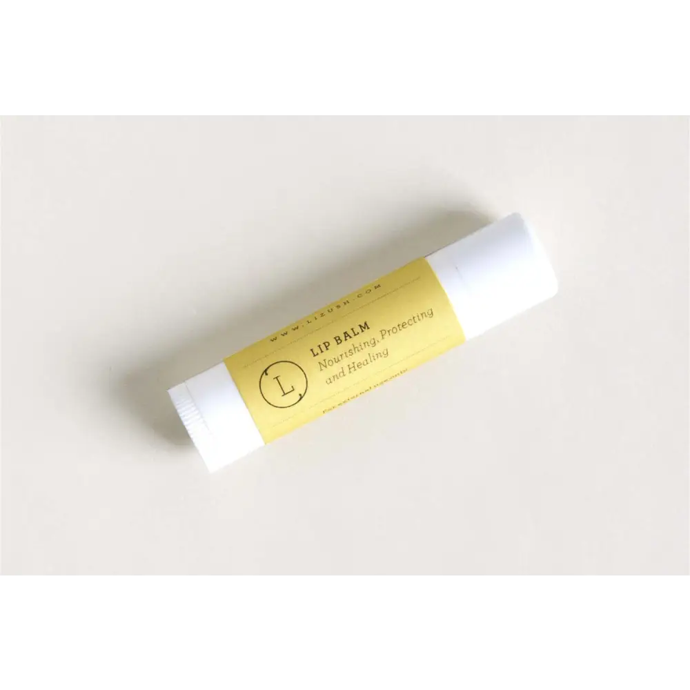Yellow-labeled lip balm with white cap featuring minimalist branding in natural citrus bath and body skincare set
