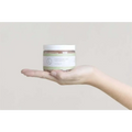 A clear glass jar with a white lid and green label containing eucalyptus bath salts for home spa body skincare products