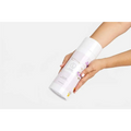 A white cylindrical container of lizash natural clay mask with floral design for body skincare products and home spa use