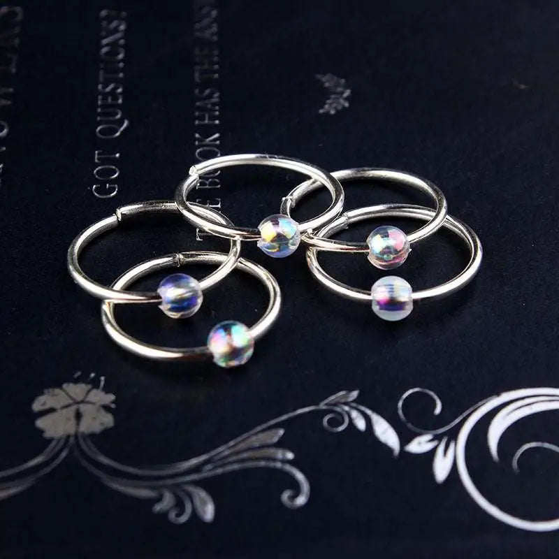Silver hoop earrings with iridescent glass beads complement natural lycopose stone decorated bead hair ties