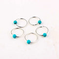 Set of five silver metal ring stitch markers with vibrant turquoise beads featuring natural lycopose stone accents