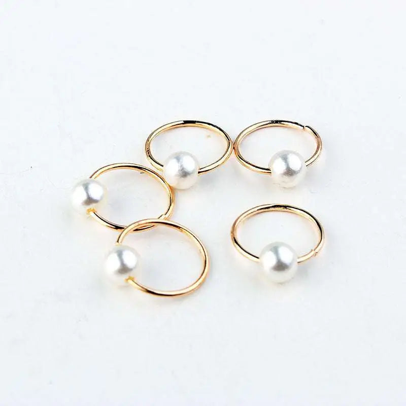 Gold-toned hoop earrings with single white pearl paired with natural lycopose stone decorated wood bead hair ties