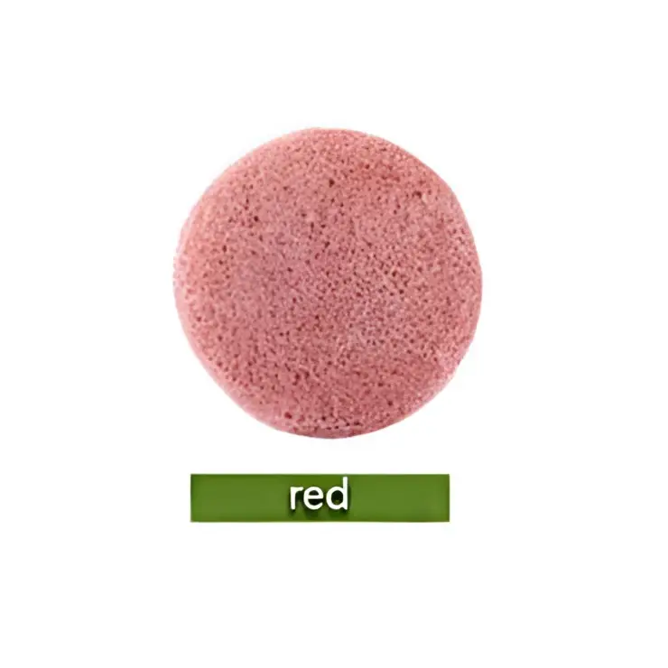 Natural round shap konjac sponge face cleaning puff in green with a porous textured surface for gentle cleansing