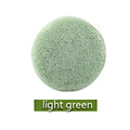 Natural round shap konjac sponge face cleaning puff with light green textured porous surface for gentle cleansing